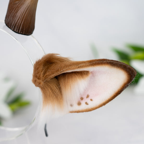 Brown deer ears with antlers